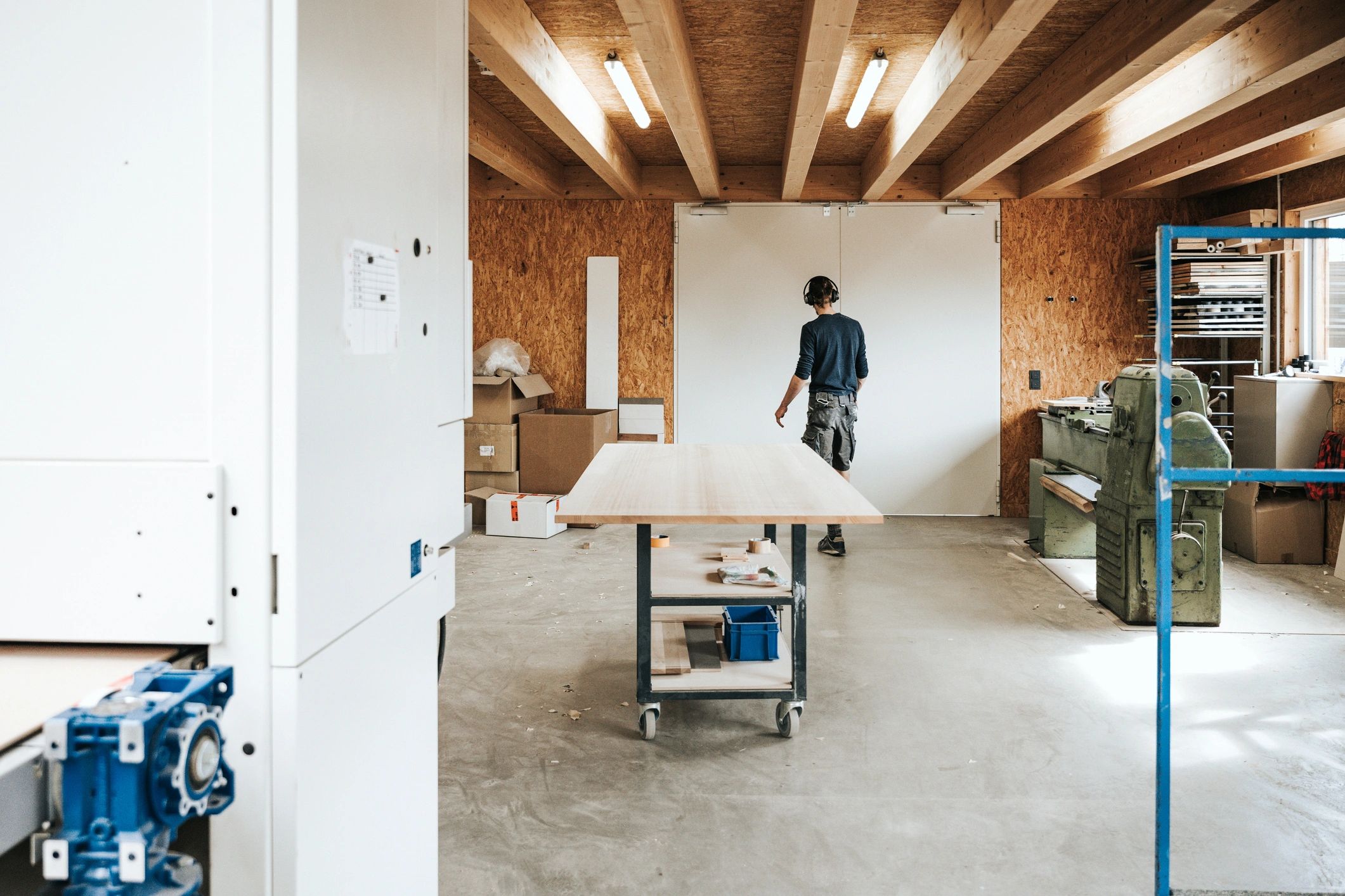 Craftsperson handling custom woodwork in workshop
