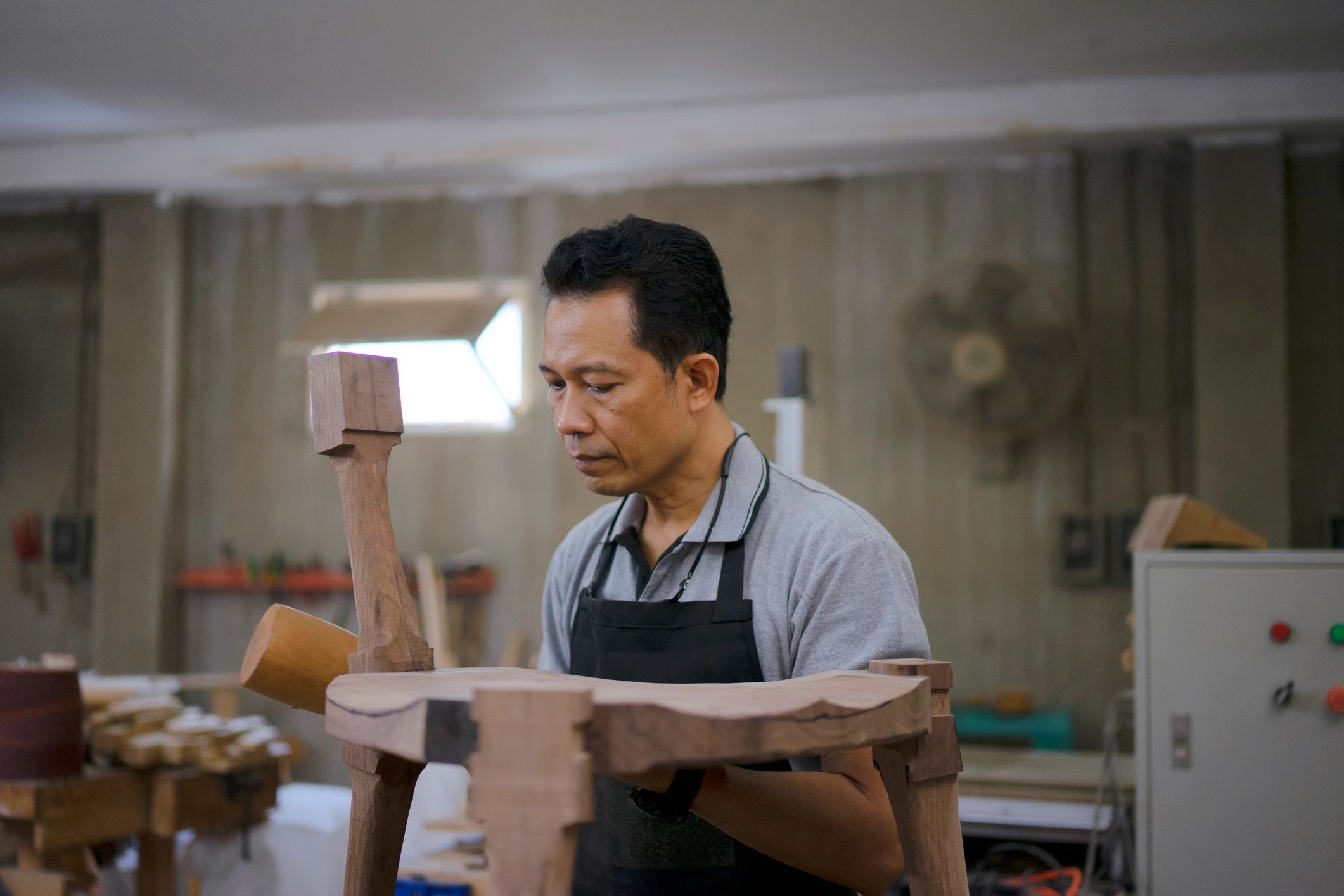Furniture maker working in a woodworking workshop