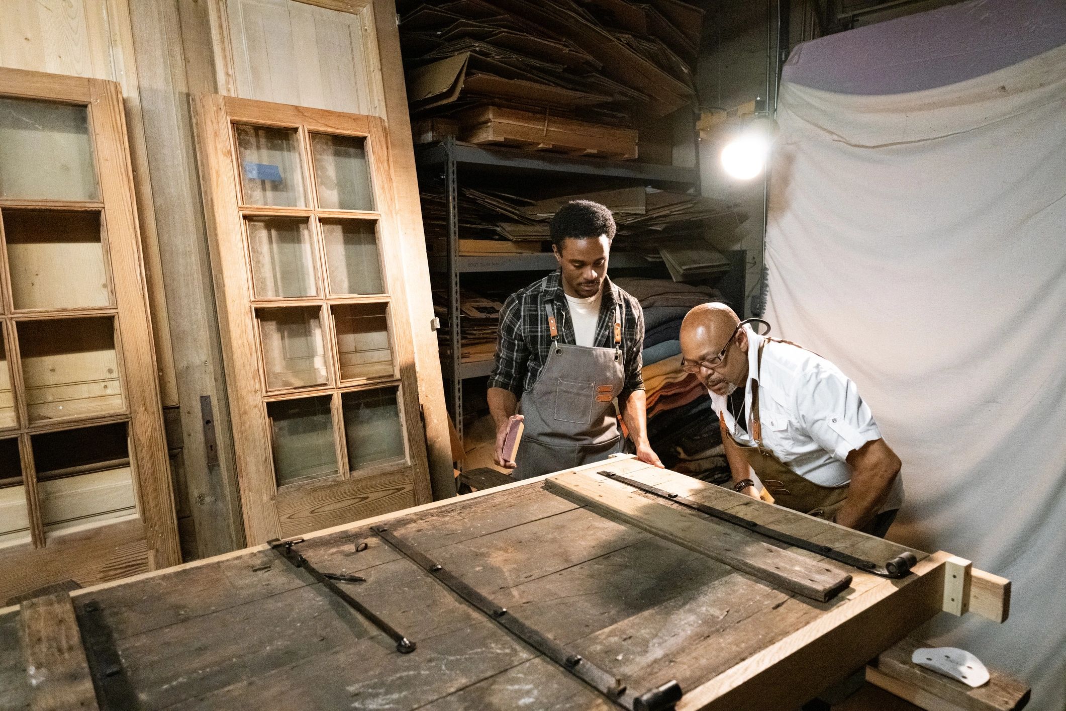 Craftspeople collaborating in a woodworking shop